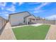 Well-maintained backyard with lush artificial turf, a paver patio, and a covered area for outdoor enjoyment at 38150 W San Sisto Ave, Maricopa, AZ 85138