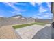 Backyard featuring artificial turf and a paver patio, perfect for outdoor activities and entertaining at 38150 W San Sisto Ave, Maricopa, AZ 85138