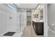 Modern bathroom featuring a glass-enclosed shower and double vanity with ample lighting and a walk in closet at 38150 W San Sisto Ave, Maricopa, AZ 85138