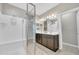 Bright bathroom with a glass enclosed shower and double vanity and neutral gray toned walls at 38150 W San Sisto Ave, Maricopa, AZ 85138
