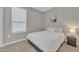 Calm bedroom with comfortable bed, nightstand, and a large window to offer plenty of natural light at 38150 W San Sisto Ave, Maricopa, AZ 85138