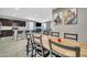 Open-concept kitchen and dining area with modern tile flooring and stylish decor at 38150 W San Sisto Ave, Maricopa, AZ 85138