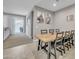 Spacious dining area with a large wooden table and seating, with a view to the backyard at 38150 W San Sisto Ave, Maricopa, AZ 85138