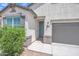 Close-up of a home's entrance featuring a blue front door and clearly visible address numbers at 38150 W San Sisto Ave, Maricopa, AZ 85138