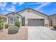 Charming single-story home with desert landscaping, gray trim, and a two-car garage at 38150 W San Sisto Ave, Maricopa, AZ 85138