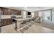 Modern kitchen with granite countertops, stainless steel appliances, and breakfast bar seating at 38150 W San Sisto Ave, Maricopa, AZ 85138
