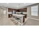 Well-equipped kitchen with granite countertops, dark cabinets, and stainless steel appliances at 38150 W San Sisto Ave, Maricopa, AZ 85138