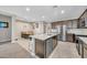 Open kitchen features granite countertops, stainless steel appliances, and a large center island at 38150 W San Sisto Ave, Maricopa, AZ 85138