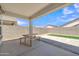 Covered patio with a picnic table overlooking the backyard, perfect for outdoor dining and relaxation at 38150 W San Sisto Ave, Maricopa, AZ 85138