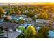 Beautiful sunset aerial view of neighborhood homes near mountains with mature trees at 3824 N 50Th Pl, Phoenix, AZ 85018
