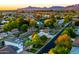 Beautiful aerial view of a charming neighborhood with lush greenery and stunning mountain views at sunset at 3824 N 50Th Pl, Phoenix, AZ 85018