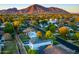 Scenic aerial view of a residential neighborhood with tree-lined streets and a backdrop of majestic mountains at 3824 N 50Th Pl, Phoenix, AZ 85018