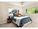 Bedroom featuring neutral carpet, natural light, and a bed made with colorful pillows at 3824 N 50Th Pl, Phoenix, AZ 85018