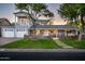 Charming two-story home with inviting front porch, stone accents, lush lawn, and a spacious driveway leading to the garage at 3824 N 50Th Pl, Phoenix, AZ 85018