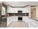 Modern kitchen with stainless steel appliances, stylish backsplash, and white cabinets offering a clean and contemporary design at 3824 N 50Th Pl, Phoenix, AZ 85018