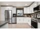 Well-lit kitchen with stainless steel appliances, sleek countertops, and modern white cabinetry for a clean, stylish look at 3824 N 50Th Pl, Phoenix, AZ 85018