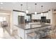 Bright kitchen boasts stainless steel appliances, quartz counters and island seating for four at 3824 N 50Th Pl, Phoenix, AZ 85018