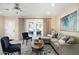 Comfortable living room with stylish furniture, a patterned rug, and access to the outdoors through elegant French doors at 3824 N 50Th Pl, Phoenix, AZ 85018