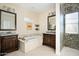 Luxurious main bathroom features double vanities, soaking tub, and glass enclosed shower at 3824 N 50Th Pl, Phoenix, AZ 85018