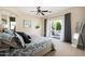 Bright main bedroom featuring neutral walls, ceiling fan, balcony access and an ensuite bath at 3824 N 50Th Pl, Phoenix, AZ 85018