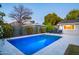 Relaxing backyard oasis featuring a sparkling pool, manicured lawn, and comfortable lounge chairs at 3824 N 50Th Pl, Phoenix, AZ 85018
