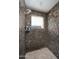 Tiled shower featuring dual shower heads and natural light through a window at 3824 N 50Th Pl, Phoenix, AZ 85018