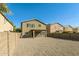 Gravel backyard featuring a covered patio, block fence and a view of neighboring houses at 409 E Saddle Way, San Tan Valley, AZ 85143