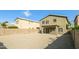Gravel backyard with block wall featuring a covered patio with access to the home's rear entrance at 409 E Saddle Way, San Tan Valley, AZ 85143