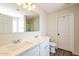 Bright bathroom featuring double sinks, white cabinets, and a large mirror at 409 E Saddle Way, San Tan Valley, AZ 85143