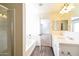 Open bathroom with a bathtub, shower, double sinks, and a doorway to another room at 409 E Saddle Way, San Tan Valley, AZ 85143