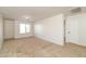 Open bedroom with neutral-colored carpet, a large window, and a doorway to a white door at 409 E Saddle Way, San Tan Valley, AZ 85143