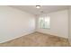 Well-lit bedroom with a carpet floor and a window that provides natural light at 409 E Saddle Way, San Tan Valley, AZ 85143