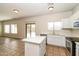 The updated kitchen features white cabinetry, stainless steel appliances, and a kitchen island at 409 E Saddle Way, San Tan Valley, AZ 85143