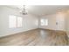 Bright living room featuring attractive wood-look flooring and a modern chandelier at 409 E Saddle Way, San Tan Valley, AZ 85143