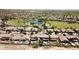 Aerial view of a planned community with green spaces, a pond and single-Gathering homes with private pools at 44236 W Adobe Cir, Maricopa, AZ 85139
