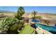 Private backyard featuring a pool, putting green and lush landscaping at 44236 W Adobe Cir, Maricopa, AZ 85139