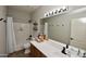 Bright bathroom featuring a full shower and bath and large vanity with plenty of storage at 44236 W Adobe Cir, Maricopa, AZ 85139