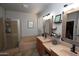 Spacious bathroom features a double sink vanity, large soaking tub and glass shower stall at 44236 W Adobe Cir, Maricopa, AZ 85139
