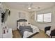 Bright bedroom with neutral paint, ceiling fan and a view of the front yard at 44236 W Adobe Cir, Maricopa, AZ 85139