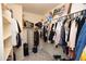 Walk-in closet with ample storage, hanging racks and built-in shelves offers plenty of room at 44236 W Adobe Cir, Maricopa, AZ 85139