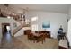 Bright dining room with high ceilings, abundant natural light, and staircase leading to upper floor at 44236 W Adobe Cir, Maricopa, AZ 85139
