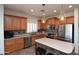 Well-equipped kitchen features stainless steel appliances, a kitchen island, and ample counter space at 44236 W Adobe Cir, Maricopa, AZ 85139