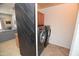 Practical laundry room with stainless steel washer and dryer and overhead storage at 44236 W Adobe Cir, Maricopa, AZ 85139