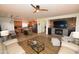 Bright and airy living space featuring modern furnishings, a fireplace, and open concept to kitchen at 44236 W Adobe Cir, Maricopa, AZ 85139