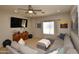 Comfortable living room with large TV, ceiling fan, plush sectional, and neutral decor at 44236 W Adobe Cir, Maricopa, AZ 85139