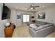 Relaxing living room with large sectional, neutral decor, and a bright window with custom blinds at 44236 W Adobe Cir, Maricopa, AZ 85139