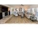 Comfortable living room featuring hardwood floors, a fireplace, and ample natural light at 44236 W Adobe Cir, Maricopa, AZ 85139