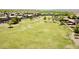 Aerial view of a large grassy field and soccer goals in a planned community at 44236 W Adobe Cir, Maricopa, AZ 85139