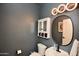 Stylish powder room featuring modern lighting, round mirror and basin sink at 44236 W Adobe Cir, Maricopa, AZ 85139