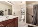 Bright bathroom features a shower, toilet, single sink vanity and a large mirror at 4441 W Windrose Dr, Glendale, AZ 85304